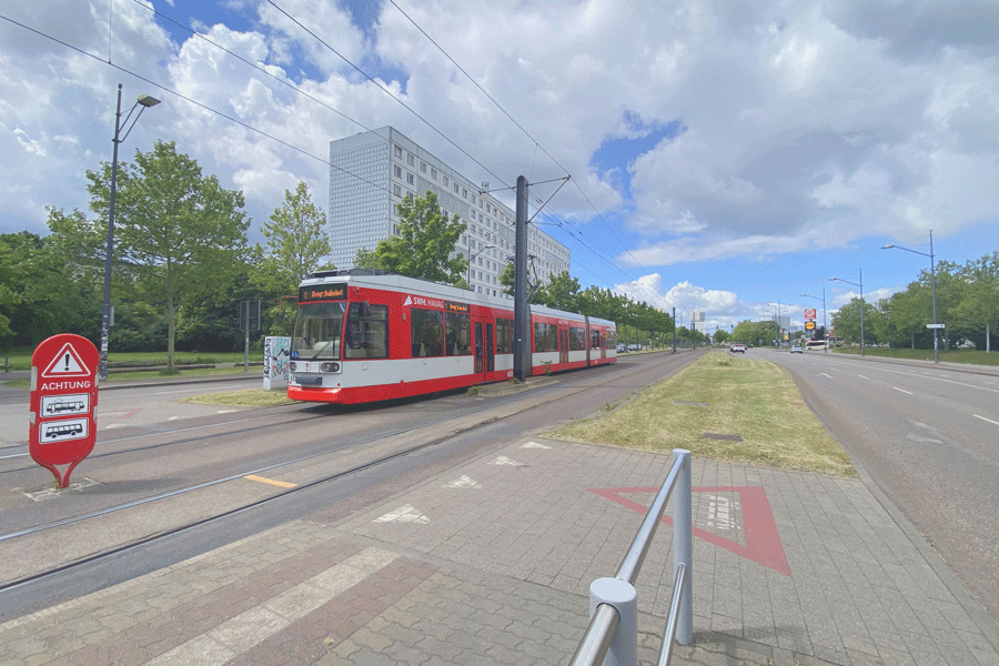 Eine Straßenbahn an der Haltestelle Schwimmhalle in Halle-Neustadt.